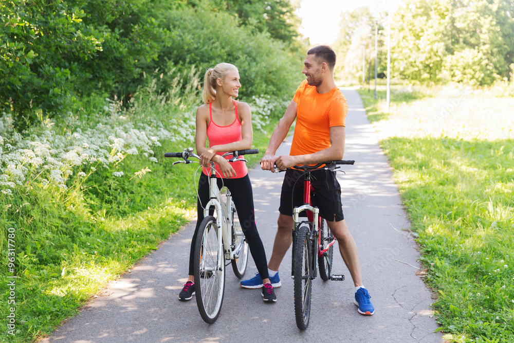 happy couple riding bicycle outdoors happy couple riding bicycle outdoors