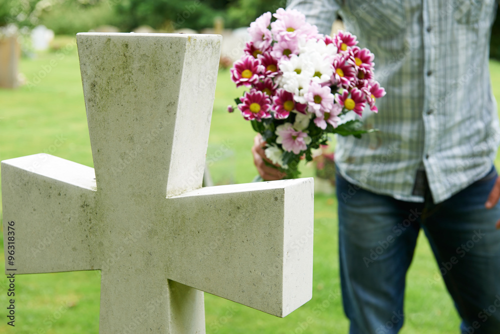 Man Laying Flowers On Grave Stock Photo | Adobe Stock