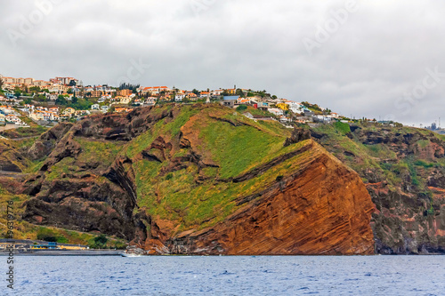 Cliff coast off town Canico, Madeira photo