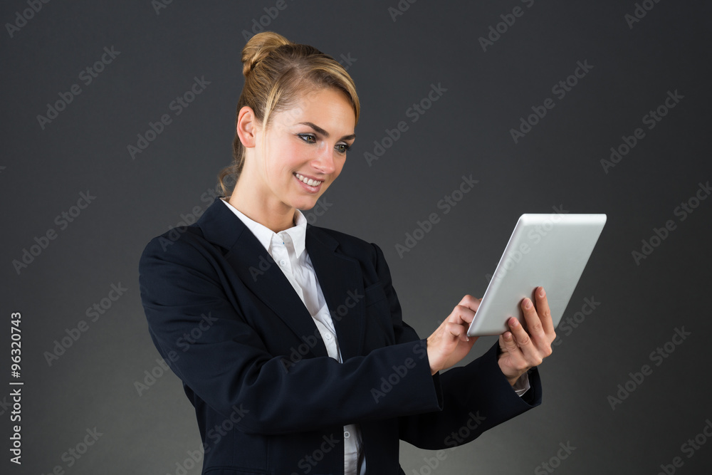Smiling Businesswoman Using Digital Tablet Smiling Businesswoman Using Digital Tablet