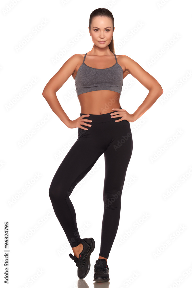 Fitness woman in sport style standing against isolated white background Fitness woman in sport style standing against isolated white background