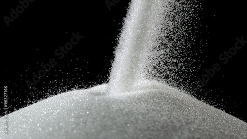 Pile of sugar on black background shooting with high speed camera, phantom flex. photo