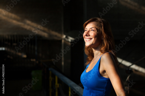 young woman smiling and enjoying sunlight