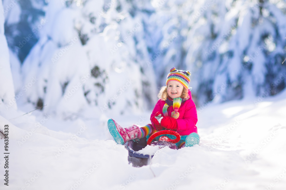 Little girl enjoying a sleigh ride.