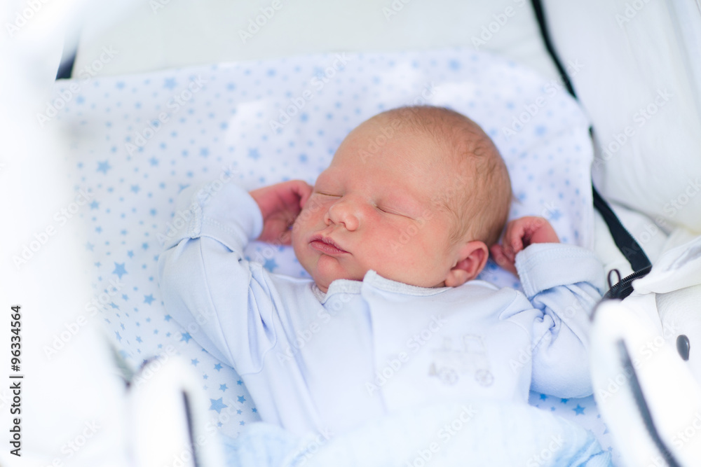 Sleeping newborn baby boy in a stroller Sleeping newborn baby boy in a stroller