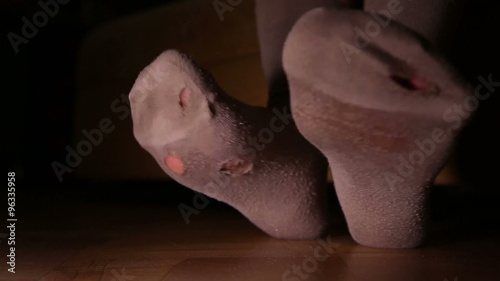 A woman wears holey socks, the symptom of poverty of a person
