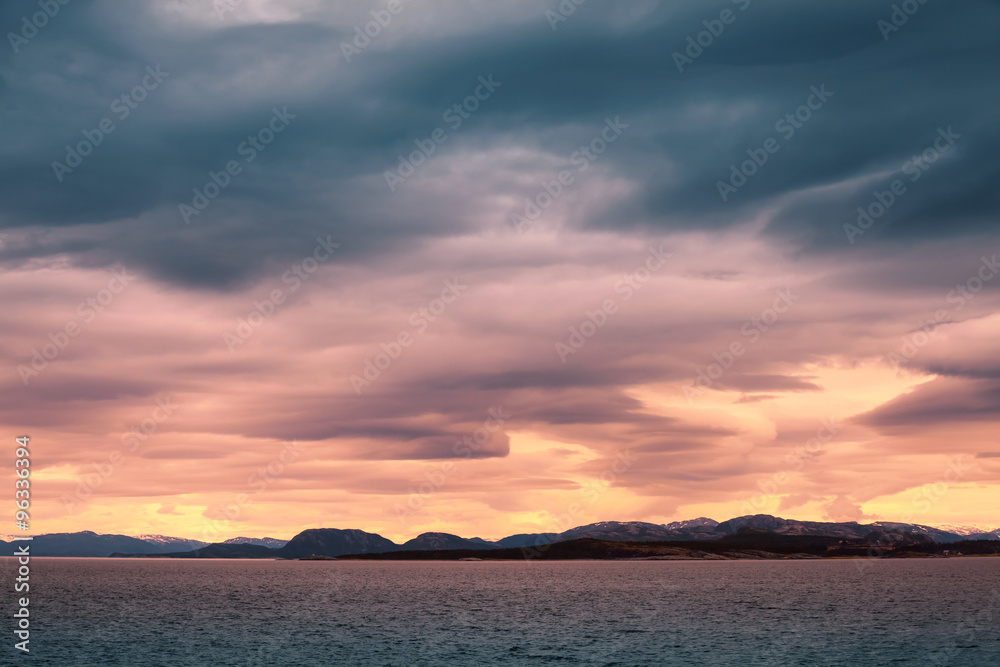 Norwegian coastal landscape, colorful stormy sky