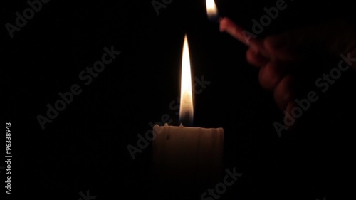 candle being lit in the dark