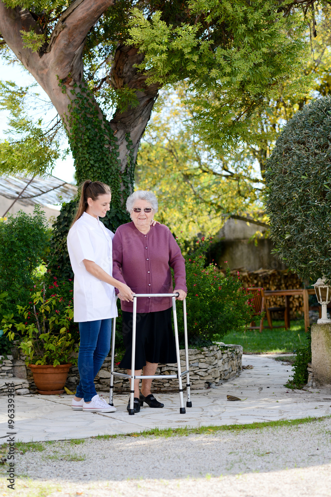 elderly senior woman with nurse walking outdoor in nursing home hospital garden elderly senior woman with nurse walking outdoor in nursing home hospital garden