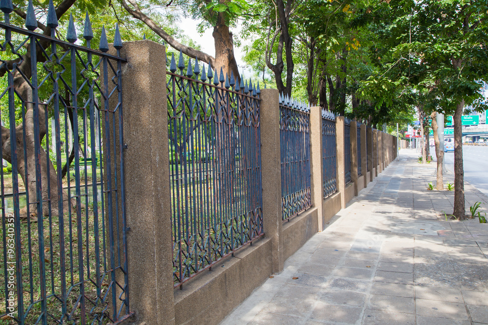 The iron fence on a green background . The iron fence on a green background .