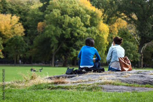 Two girls having a break in Central Park, Manhattan, New York. photo