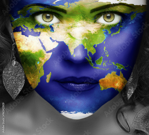 Map of the world on face of girl with green eyes