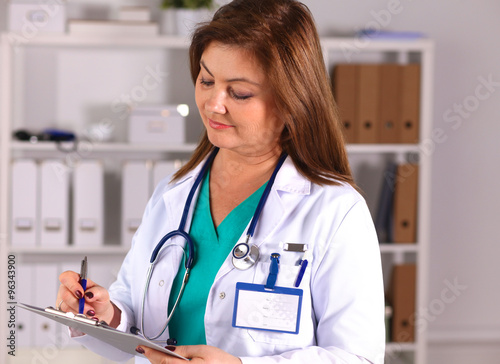 Portrait of happy medical doctor woman in office