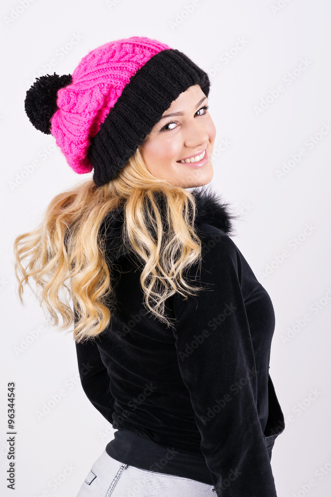 Young blonde teenage girl in sweatshirt and knitted hat Young blonde teenage girl in sweatshirt and knitted hat