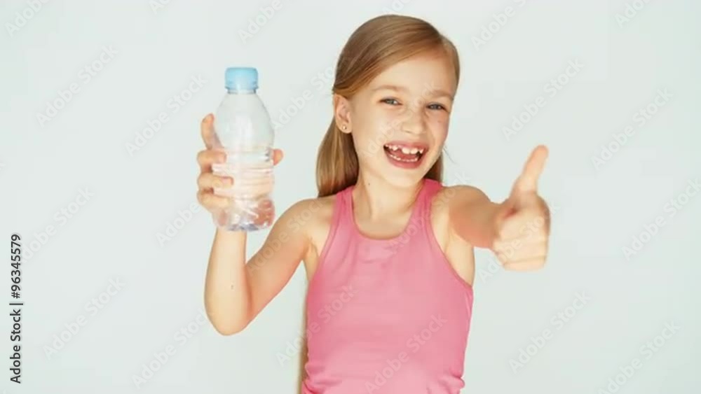 Portrait sportswoman girl child caught bottle of water and laughing at camera Portrait sportswoman girl child caught bottle of water and laughing at camera