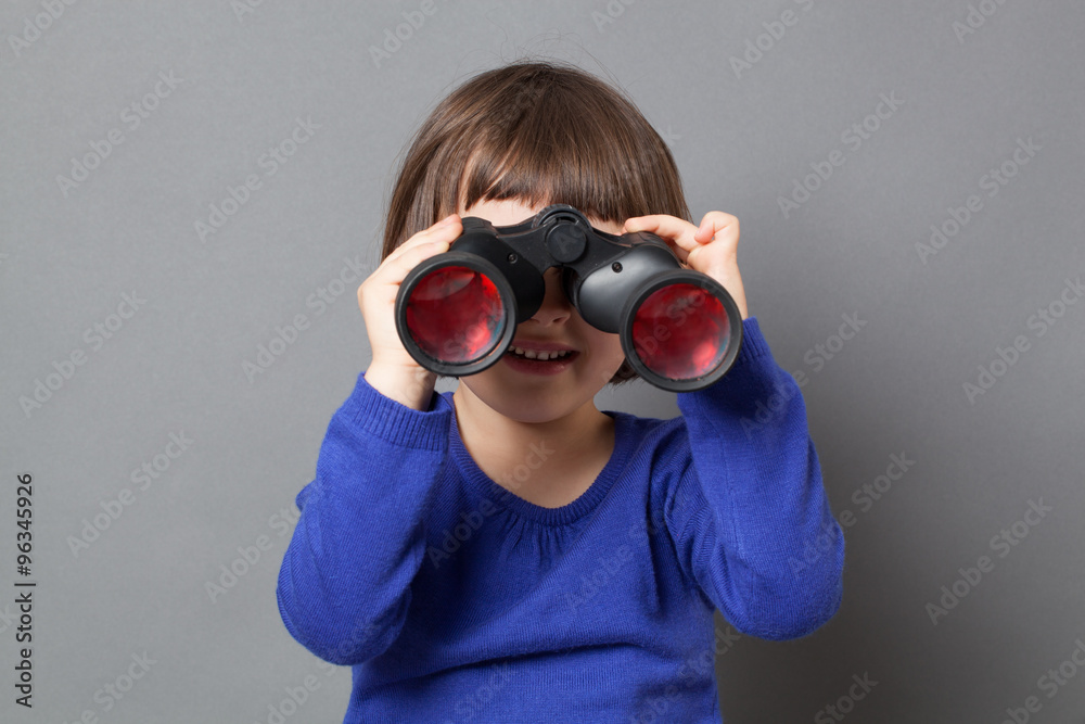 kid exploration concept - smiling 4-year old child having fun in watching through binoculars for discovery and curiosity,studio shot kid exploration concept - smiling 4-year old child having fun in watching through binoculars for discovery and curiosity,studio shot
