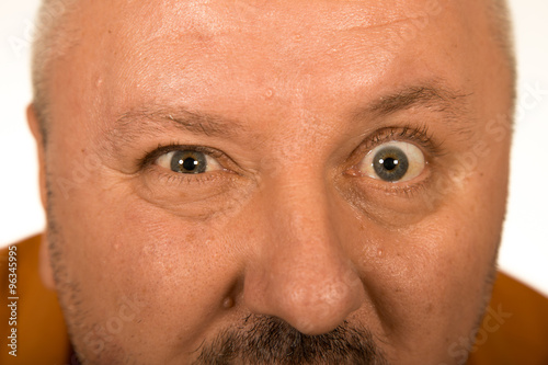 Bild auf Leinwand Man with big eyes staring at you over white background