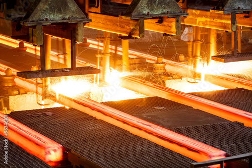 hot steel on conveyor in steel mill photo