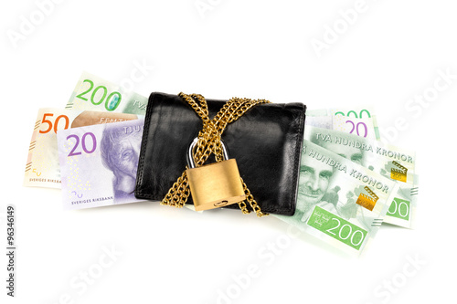 Swedish banknotes sticking out from a black wallet with chain and lock. One white background. photo