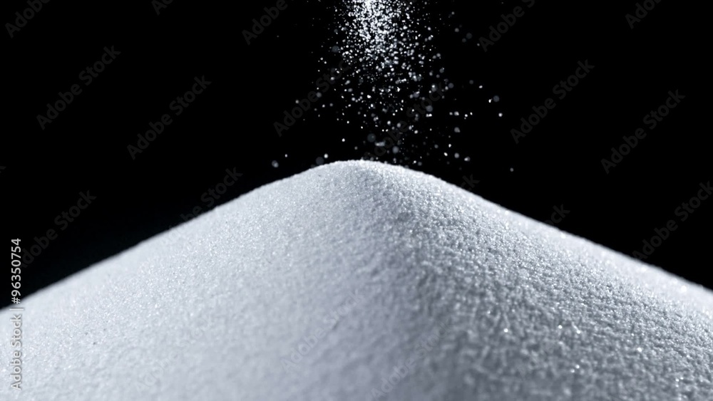 Pile of white sand on black backgroud shot with high speed camera, phantom flex.