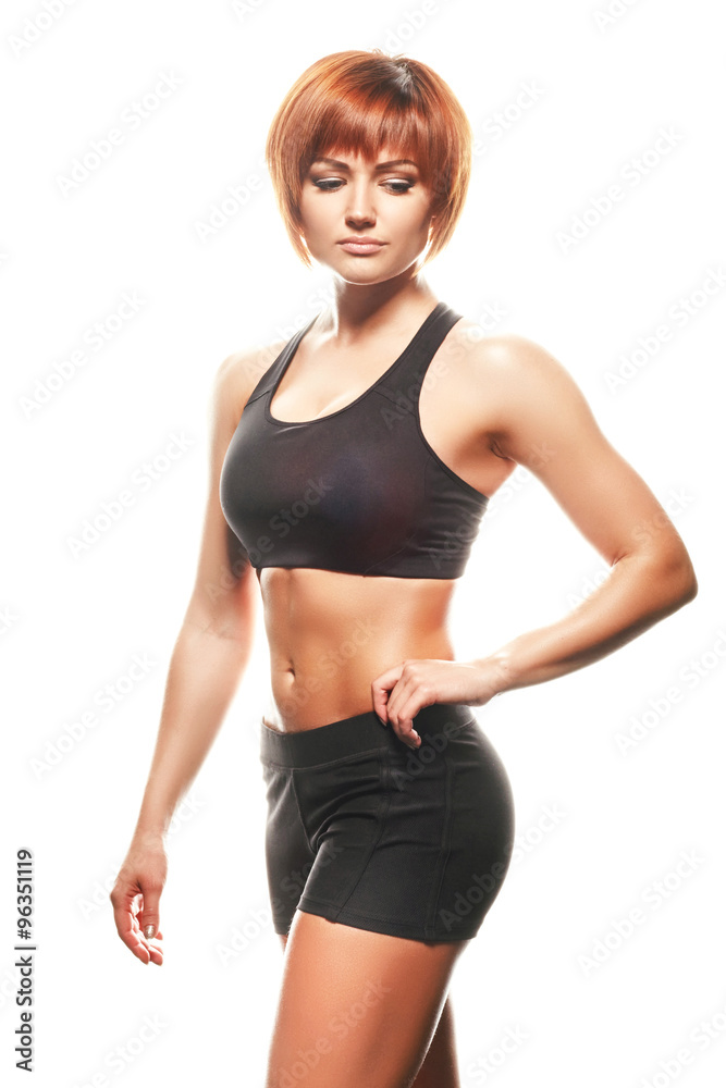Portrait of redhead woman in sportswear. Studio shot Portrait of redhead woman in sportswear. Studio shot