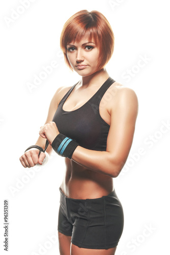 Young redhead female athlete wearing straps