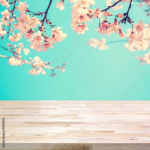 Wood table top on blur pink Sakura flower background