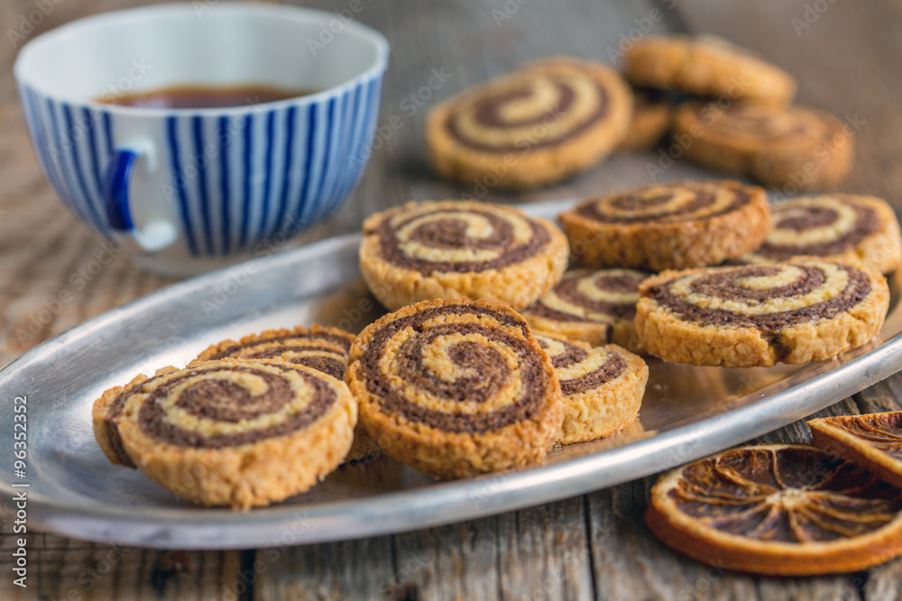 Cookies in the form of a spiral and a cup of tea.