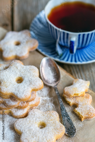 Italian cookies, spoon and a cup of tea. photo