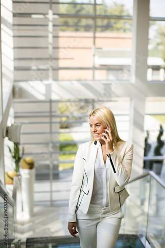 Young woman with mobile phone in the office