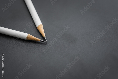 two white pencils on black