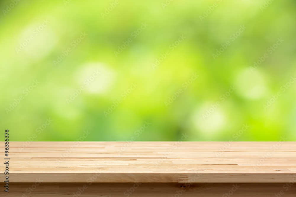 Wood table top on natural green bokeh abstract background Wood table top on natural green bokeh abstract background