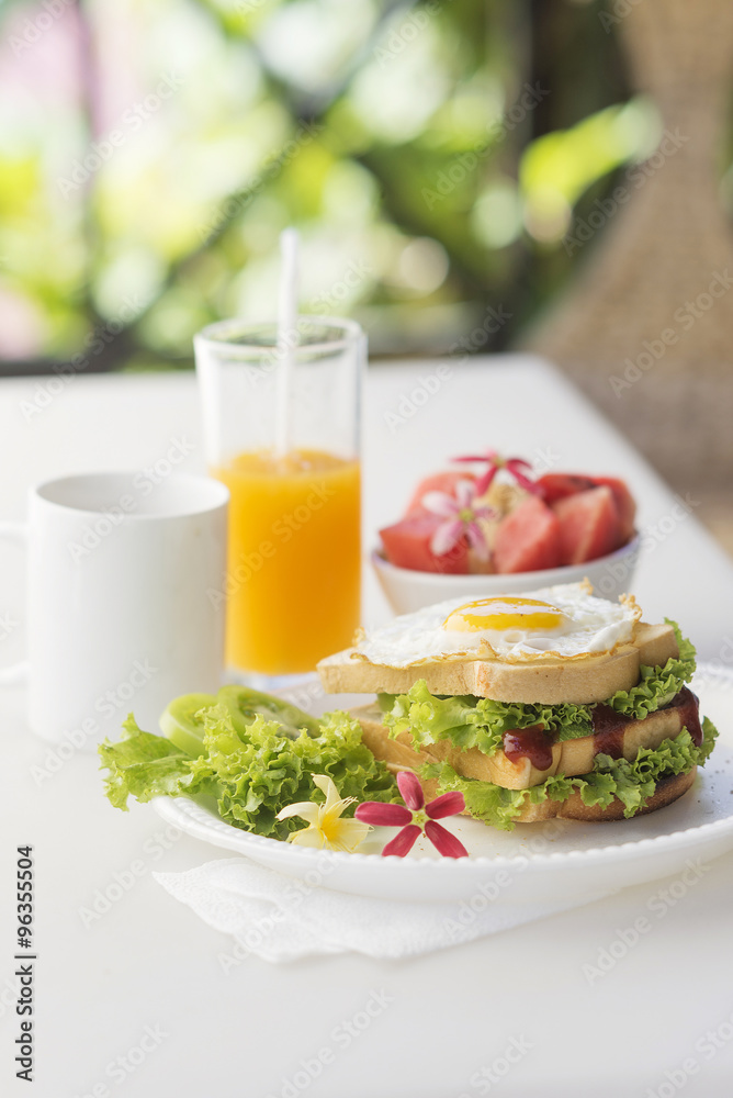 breakfast set with egg sandwich and fruit salad