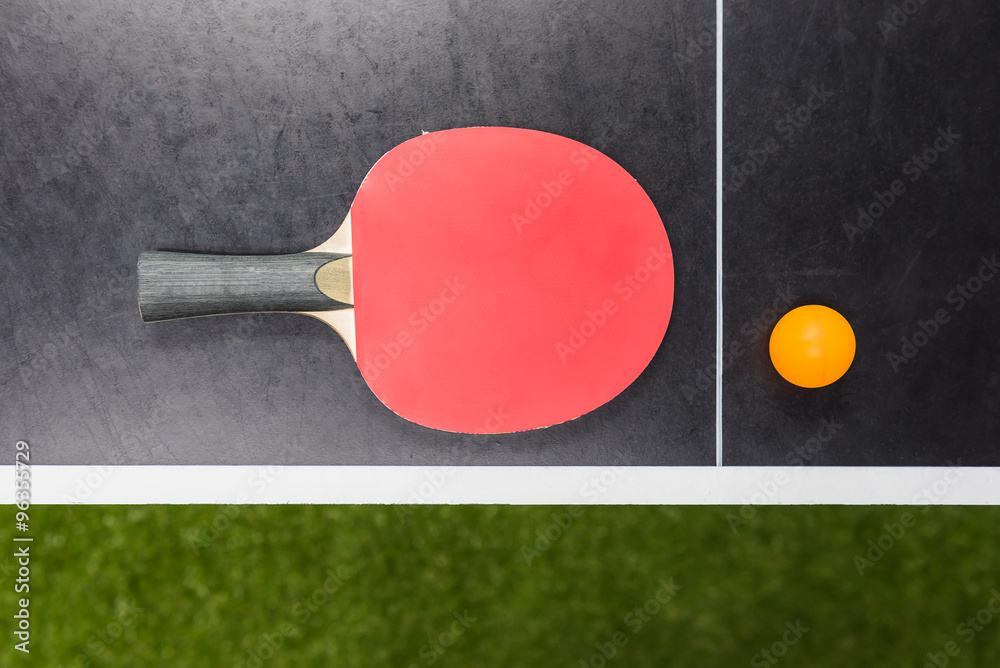 table tennis racket with ball on black table table tennis racket with ball on black table