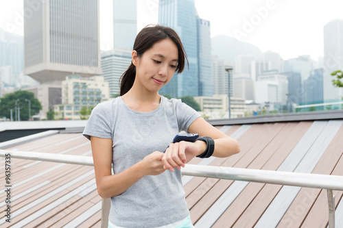Young Woman checking the data on sport watch at outdoor Free Download Young Woman checking the data on sport watch at outdoor - GFXLoad
