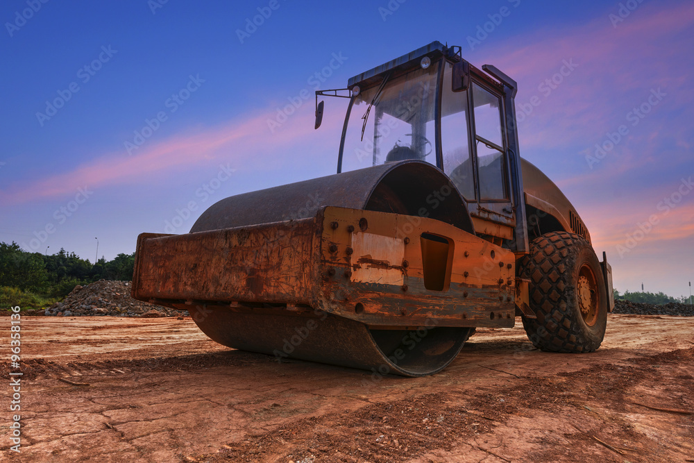 Fototapeta premium Large road-roller paving a road. Road construction
