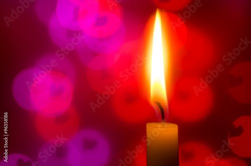 candle on heart shapes background photo