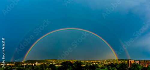 Panorama of a big summer rainbow