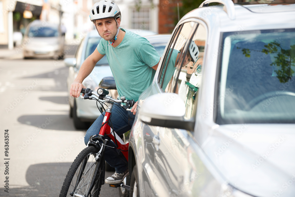 Young Man Cycling On Urban Street Young Man Cycling On Urban Street