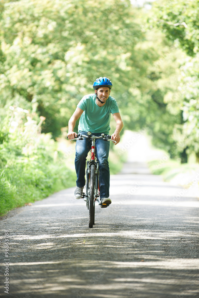 Young Man Enjoying Cycle Ride In The Countryside