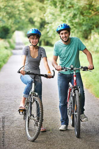 Young Couple Cycling On Country Road