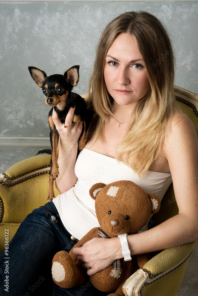 Obraz premium girl with a small dog in the Studio