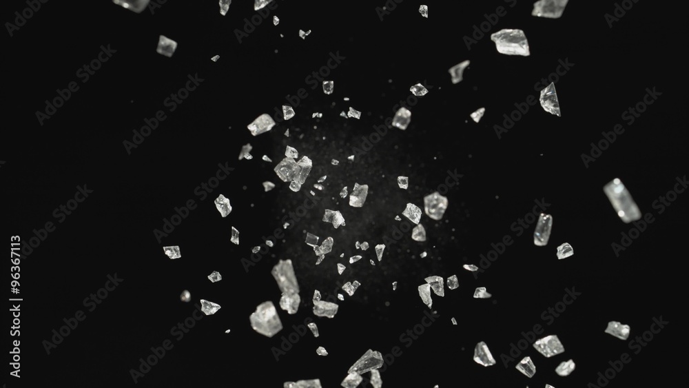 Pieces of glass fly after being exploded against black background. Shot with high speed camera, phantom flex 4K. 4K 30fps. Slow Motion. Pieces of glass fly after being exploded against black background. Shot with high speed camera, phantom flex 4K. 4K 30fps. Slow Motion.