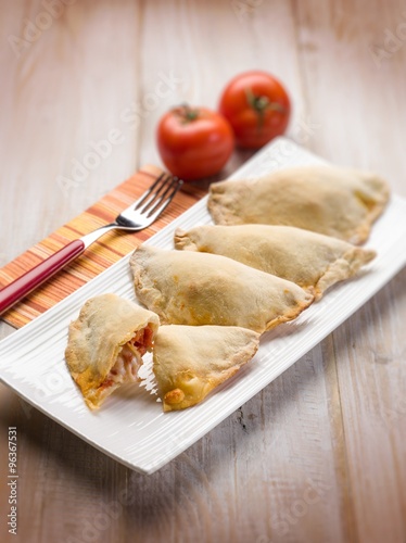 panzerotti with tomato and mozzarella selective focus