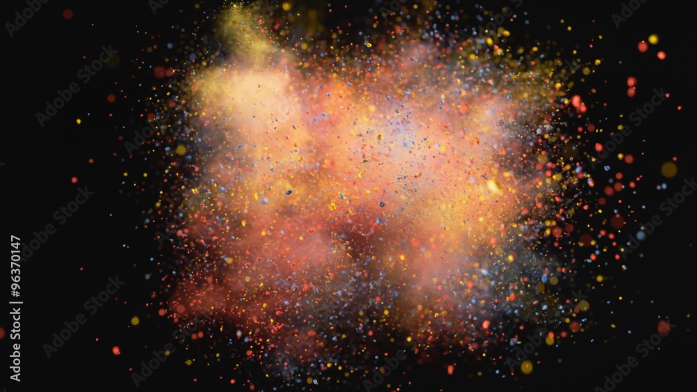 Colorful powder/particles fly after being exploded against black background. Shot with high speed camera, phantom flex 4K. 4K 30fps. Slow Motion.