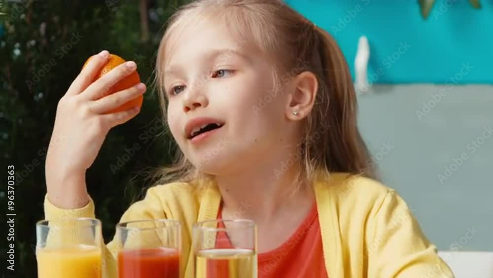 Smiling girl holding orange and smiling at camera. Thumb up. Ok Smiling girl holding orange and smiling at camera. Thumb up. Ok