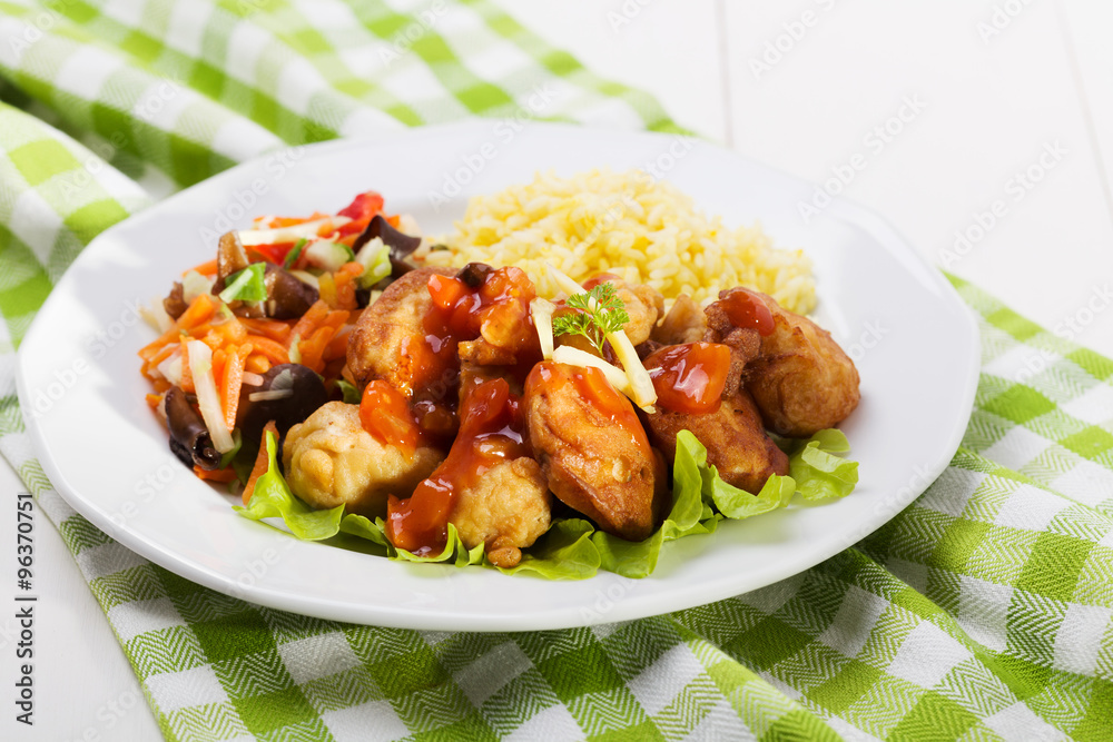 Fried chicken pieces in batter with sweet and sour sauce Fried chicken pieces in batter with sweet and sour sauce