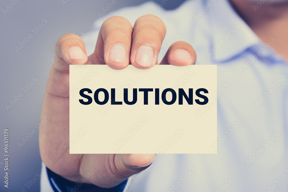 A man showing card with SOLUTIONS word A man showing card with SOLUTIONS word