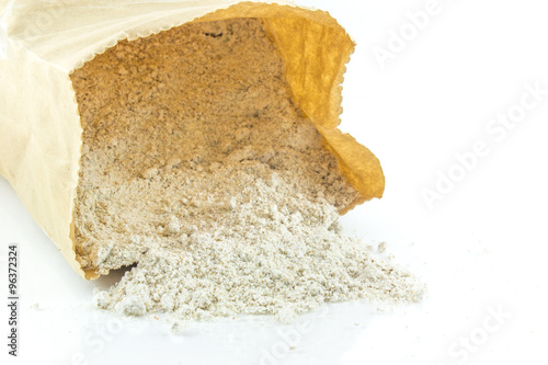 Whole wheat flour in bag on white background