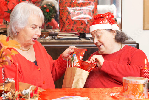 senior ladies exchanging gifts for christmas photo